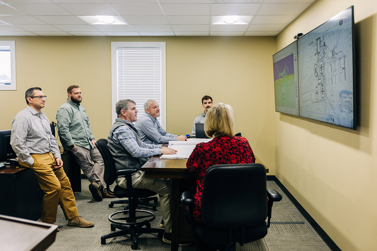 company meeting looking at plans on tvs